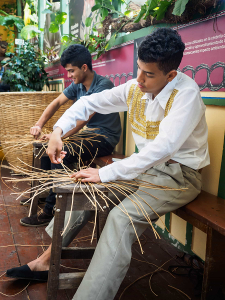 Young men at Filandia's basket museum demonstrate one of the town's traditional crafts