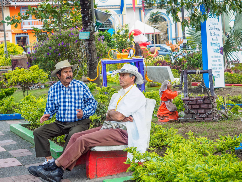 Two men relax amid the Christmas decorations in Filandia's main plaza