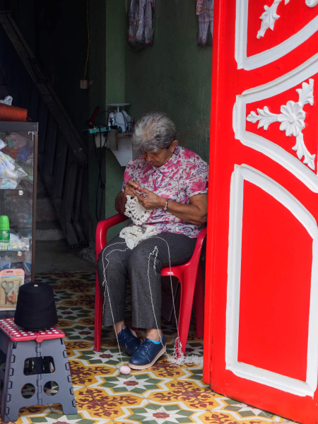 This woman crocheting in the doorway of her shop reminded Melissa of her grandma