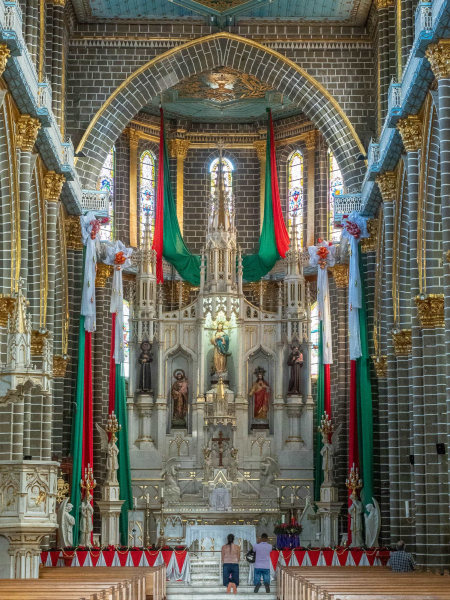 The church (decorated for Christmas) features an altar carved from Italian marble