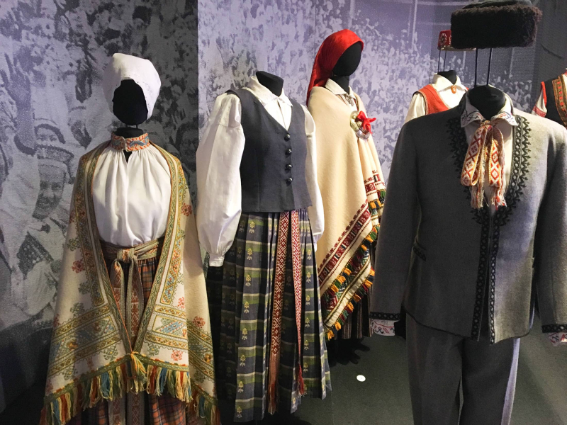 A display of traditional Latvian folk costumes from different parts of the country