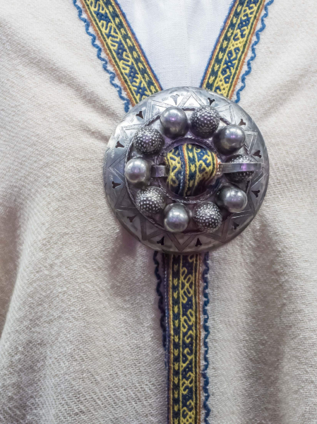 Large circular metal brooches are a distinctive part of Latvian women's traditional dress