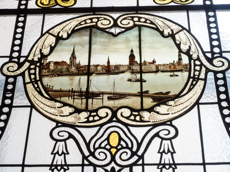 A scene of Riga's old skyline painted on a window at the National History Museum of Latvia