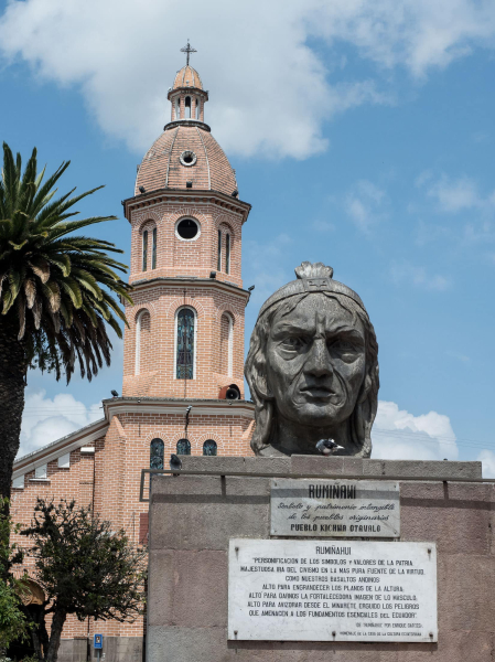 Bust of Inca warrior Ruminahui, who lead the resistence against the Spanish, in front of a Catholic church