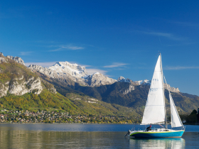 A sailboat on Lake Annecy on a beautiful late-fall day