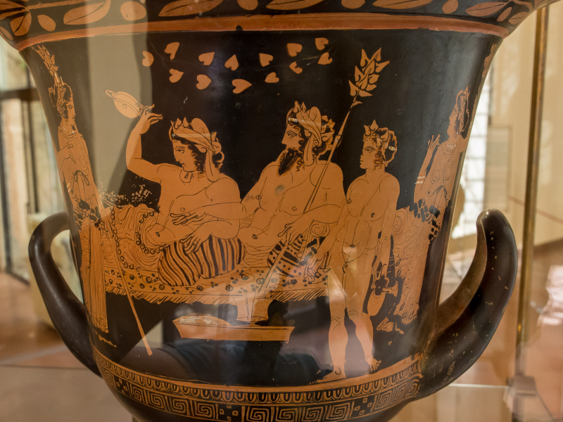 A large wine jug decorated with a party scene