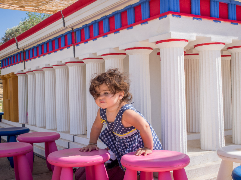 Francesca plays at a kid-size reproduction of an Agrigento temple
