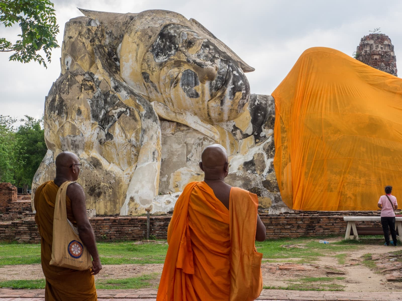 Monks admiring a giant reclining Buddha