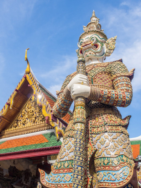 Gaudy demon statues guard the entrance to the palace's monastery, Wat Phra Kaeo