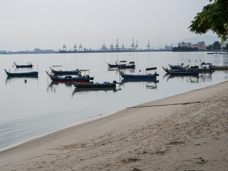 Fishing boats at the beach near our neighborhood, with Penang's shipping port in the background