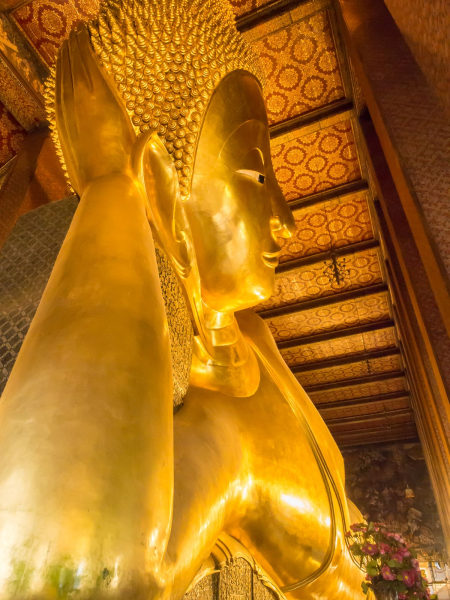 Wat Pho is famous for its enormous reclining Buddha, 50 feet high and 150 feet long