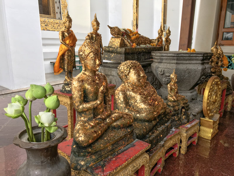 An altar where worshippers can obtain merit by applying pieces of gold leaf to some Buddha images (so as to spare the reclining Buddha and other famous statues)