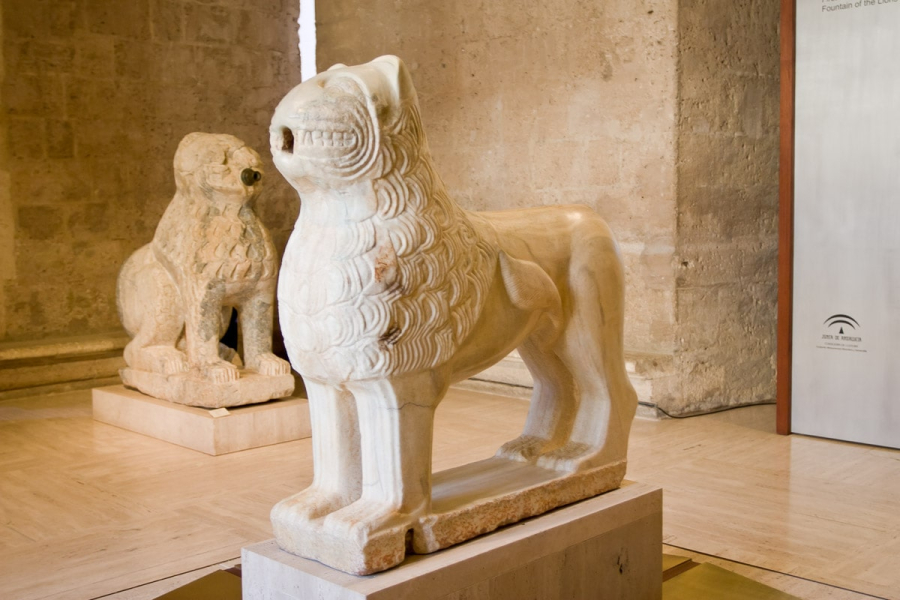 One of the marble lions from the Fountain of the Lions, newly restored and on display in the Museum of the Alhambra. (An unrestored lion is behind it.)