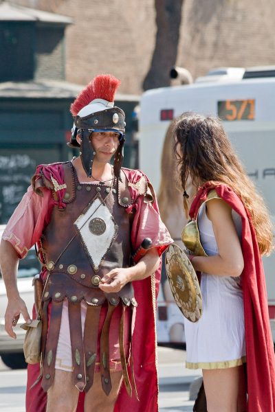 "Gladiators" wait outside the Colosseum to take pictures with tourists