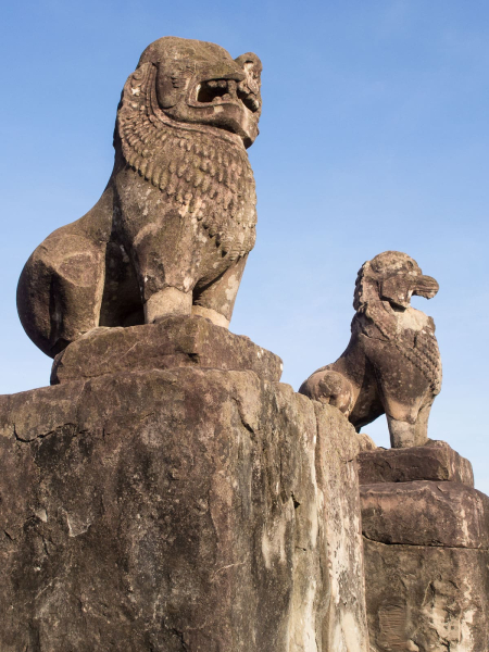 The steep steps up to each level are flanked by lion statues
