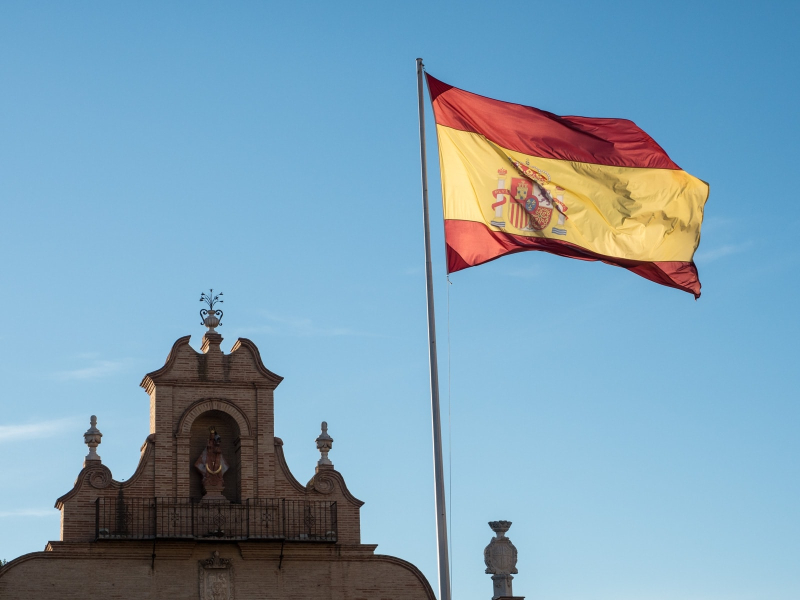 The Spanish flag flies over a city gate in Antequera