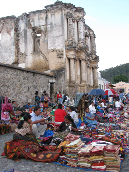 An outdoor craft market outside a ruined church