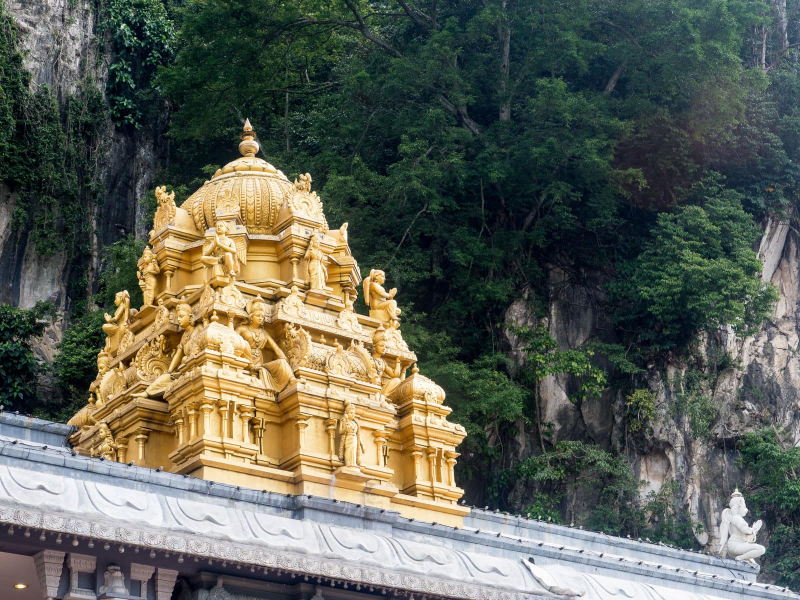 A roof decoration with the dramatic Batu cliffs behind it