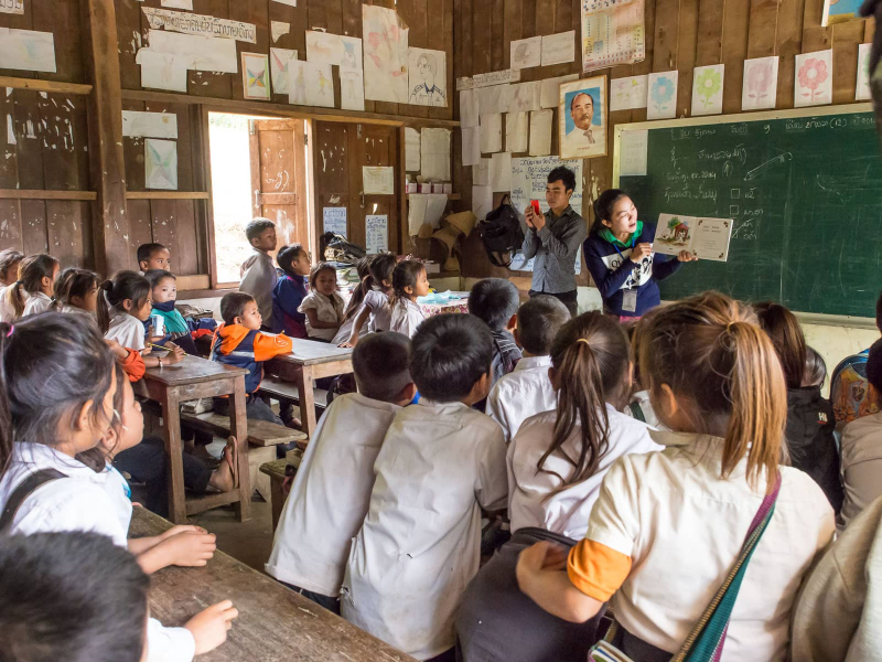 A BBM staff member reads aloud to a classroom (being read a story is a new idea in Laos, where oral storytelling and TV shows are more common)