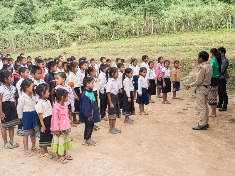 The head teacher (in khaki) introduces the Big Brother Mouse staff to the students