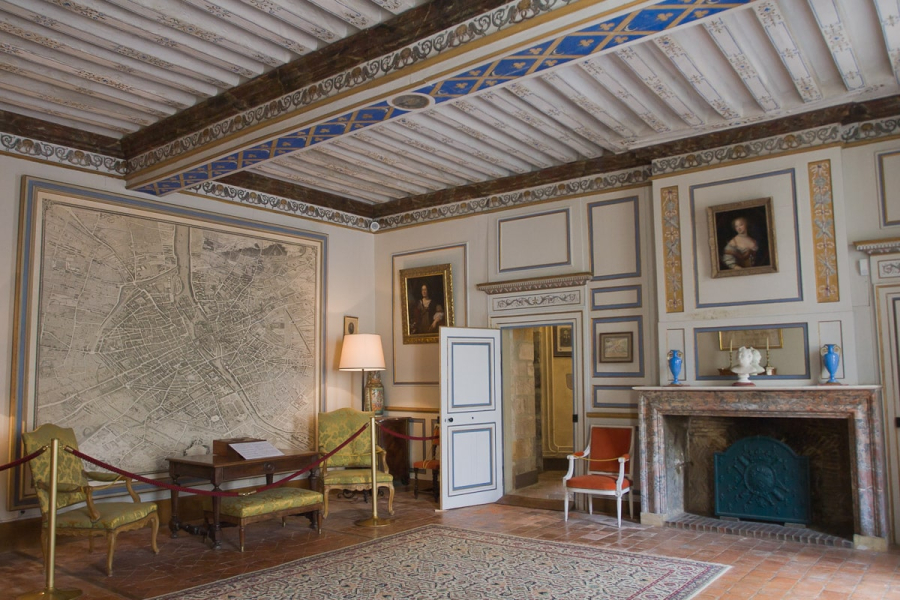 A 17th century map of Paris dominates the drawing room