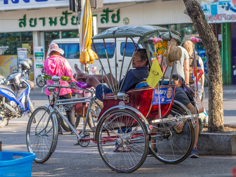 A pedicab driver resting between customers