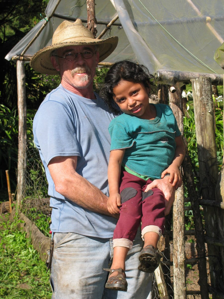The finca's owner, Ken, with 5-year-old Olga, the daughter of the farm's local manager