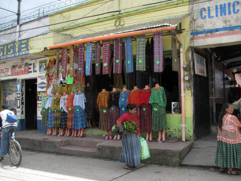 A shop selling the full, pleated skirts and synthetic, colored, lacy blouses that women in Coban wear now 