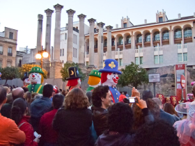 Old and new in Cordoba: floats in the annual Carnival parade pass by Roman columns.