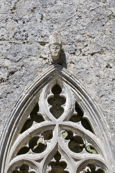 Carved head of a bishop above a window in the cathedral