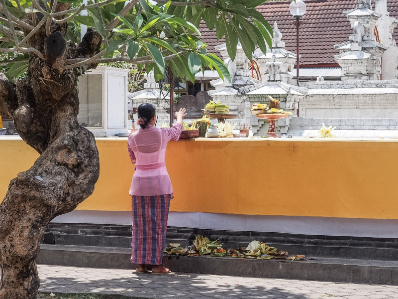 A woman leaving offerings at the state temple
