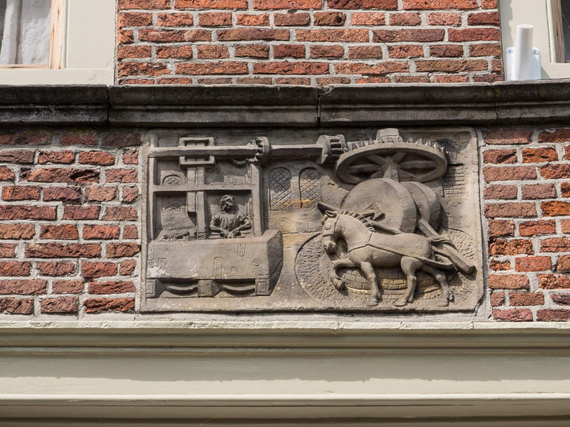 Many old buildings have plaques displaying their function (this was some kind of horse-powered press)