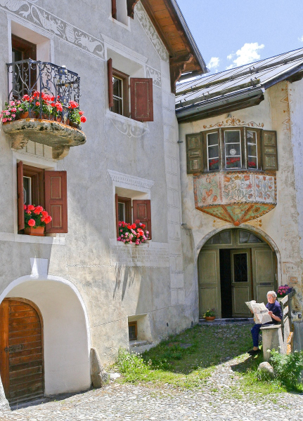 Houses in Guarda typically feature oval doorways, multipaneled doors, sgraffito wall decoration, and a bench outside