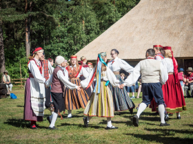 Folk dancers in traditional dress from different regions of Estonia perform at the Open Air Museum near Tallinn