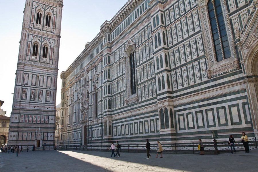 The 14th century duomo and campanile are faced in slabs of white, green, and pink marble