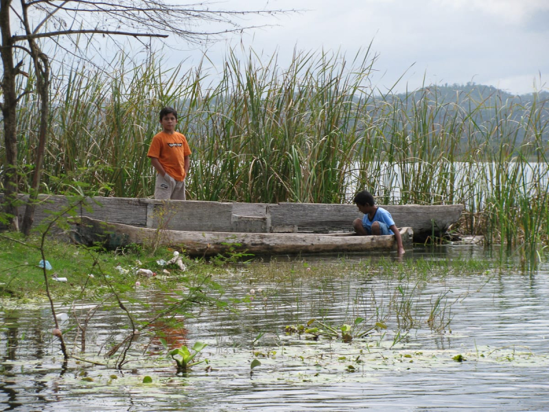 Boys playing in traditional canoes