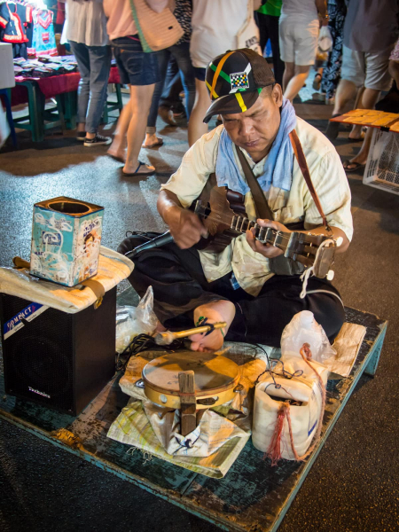 This musician accompanied himself on guitar by playing a drum with his foot