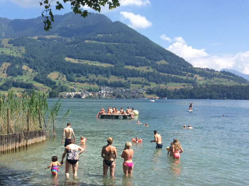 Francesca and Chris (far left) take a dip in Lake Lucerne at Merlishachen