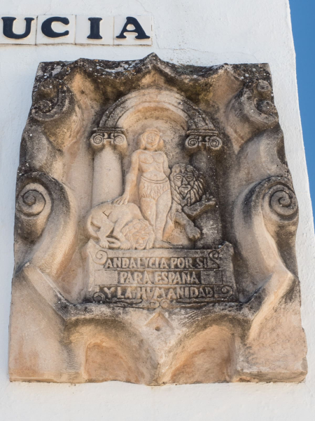 A carving of the modern coat of arms of southern Spain ("Andalucia by herself, for Spain and humanity")