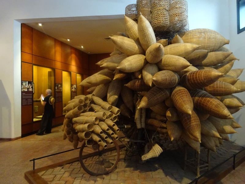 The Ethnology Museum honors traditional bicycle peddlers, including one who piled a bike with an enormous load of fish and eel traps