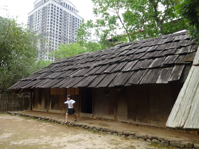 This low, long house with wooden shingles (which can be moved to provide light) was built by a Hmong family in northern Vietnam