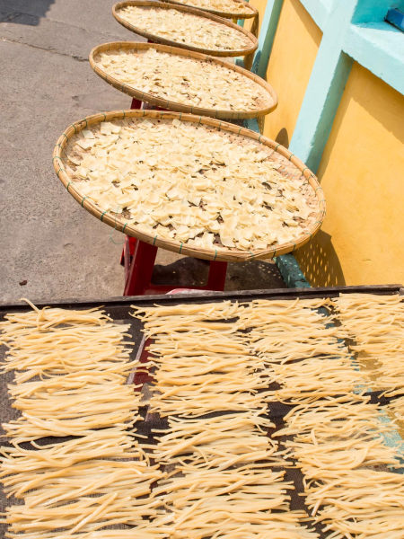 Noodles of various shapes drying in the sun