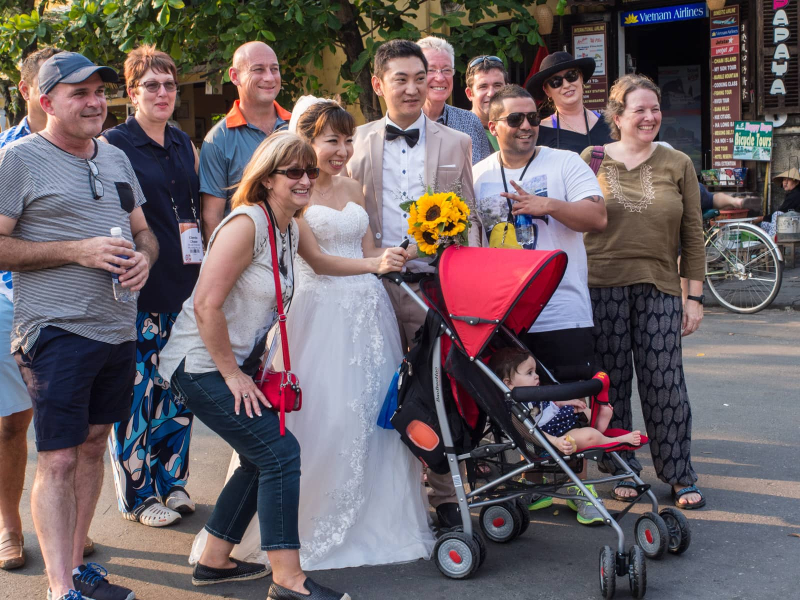 Chris, baby Francesca, and an Australian tour group got pulled into a couple's wedding photos