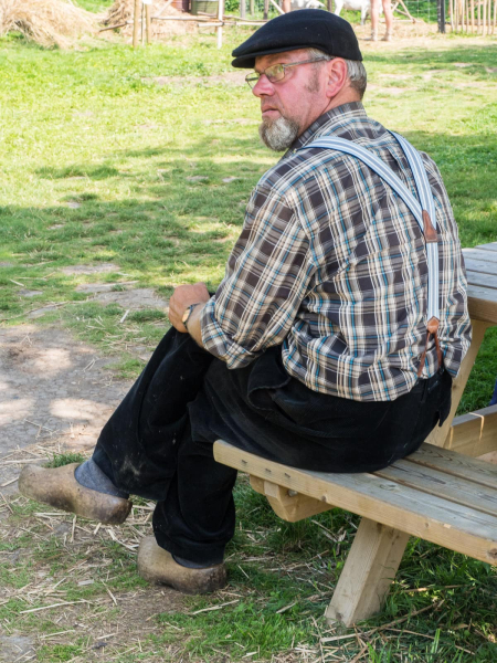 A mill volunteer wearing traditional wooden clogs