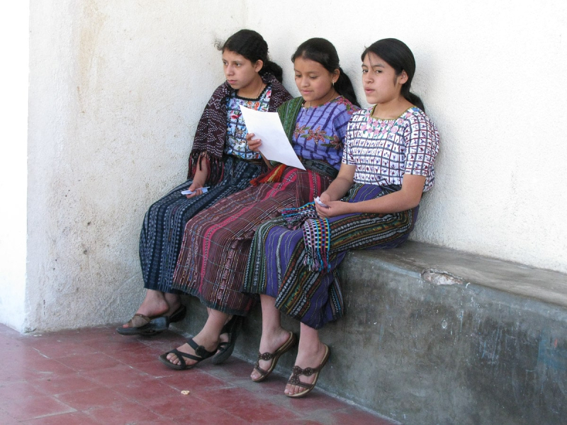 Three school girls in Santiago wearing the striped skirts and heavily embroidered blouses typical of the Lake Atitlan region