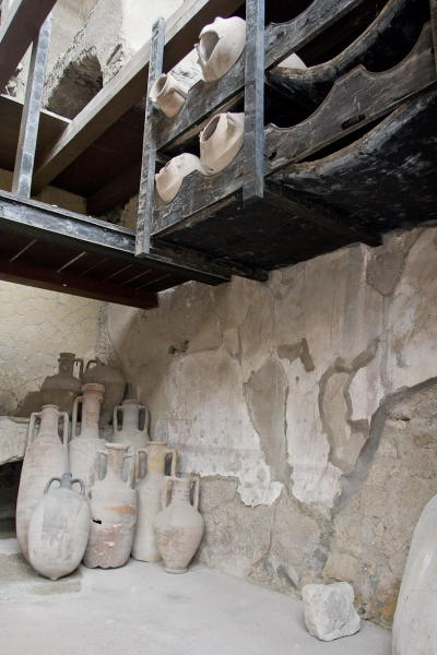 A Roman wine bar, with original wooden shelves preserved in the lava