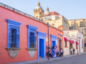 Colorful old houses (now shops and restaurants) in the shadow of Santo Domingo church