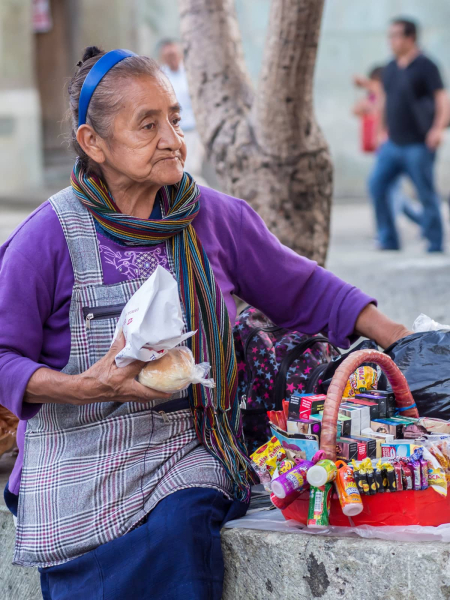 A street vendor selling cigarettes and candy stops for a rest
