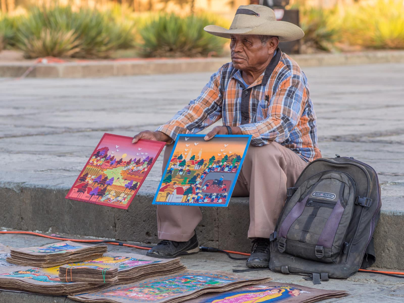 An artist sells his paintings outside the Santo Domingo church