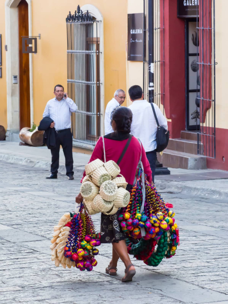 A vendor selling woven baskets and Christmas decorations
